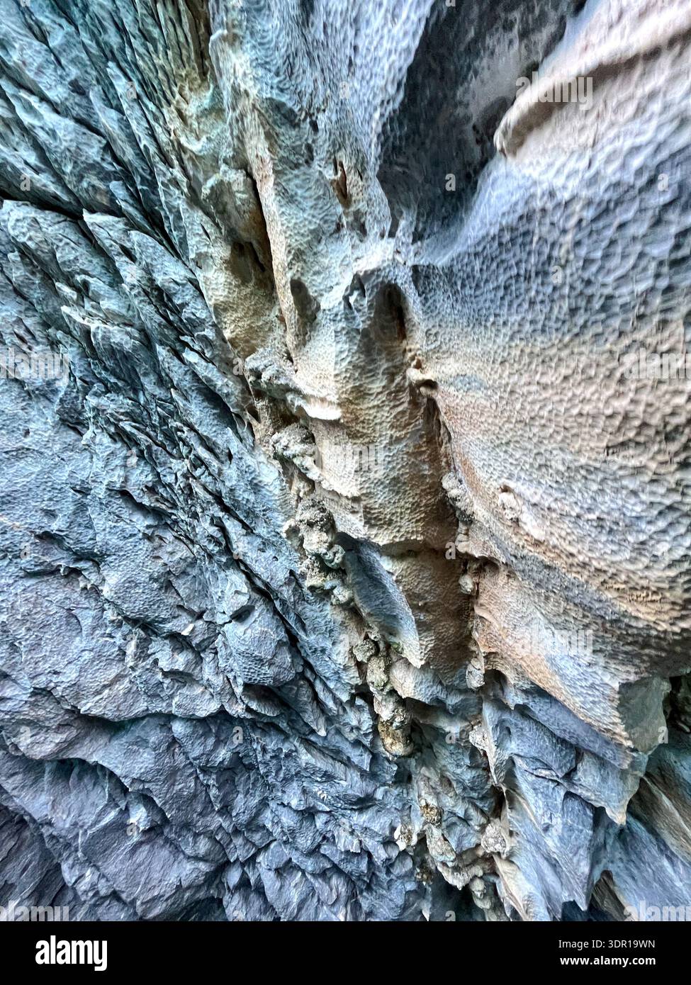 Close-up detail of natural marble stone surface showing intricate mineral veining, subtle tonal variations, and irregular crystalline structure. Stock Photo