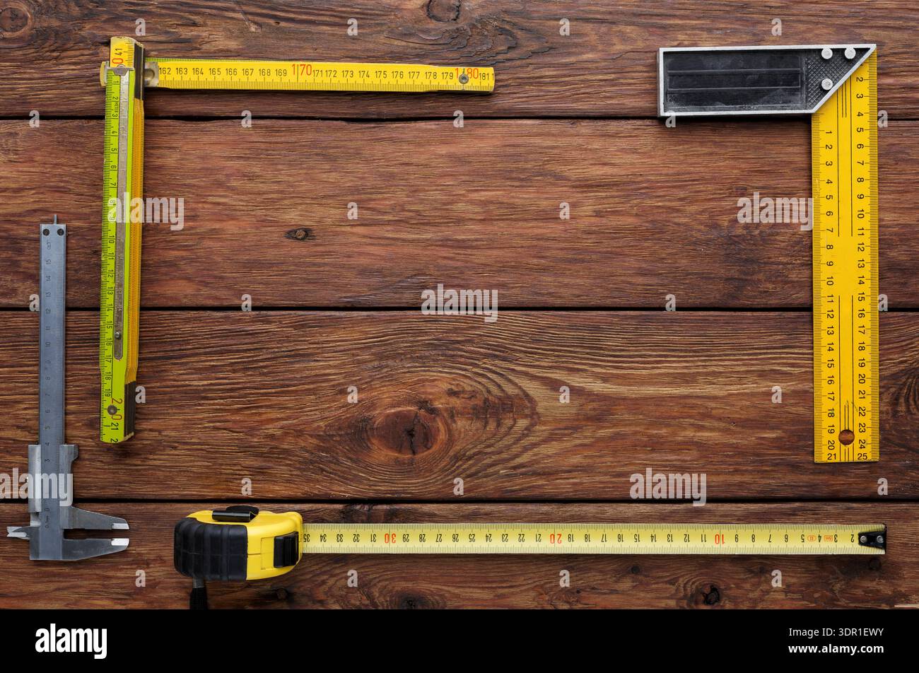 Tools for Measuring and Layout on Wooden Surface During Construction Process Stock Photo