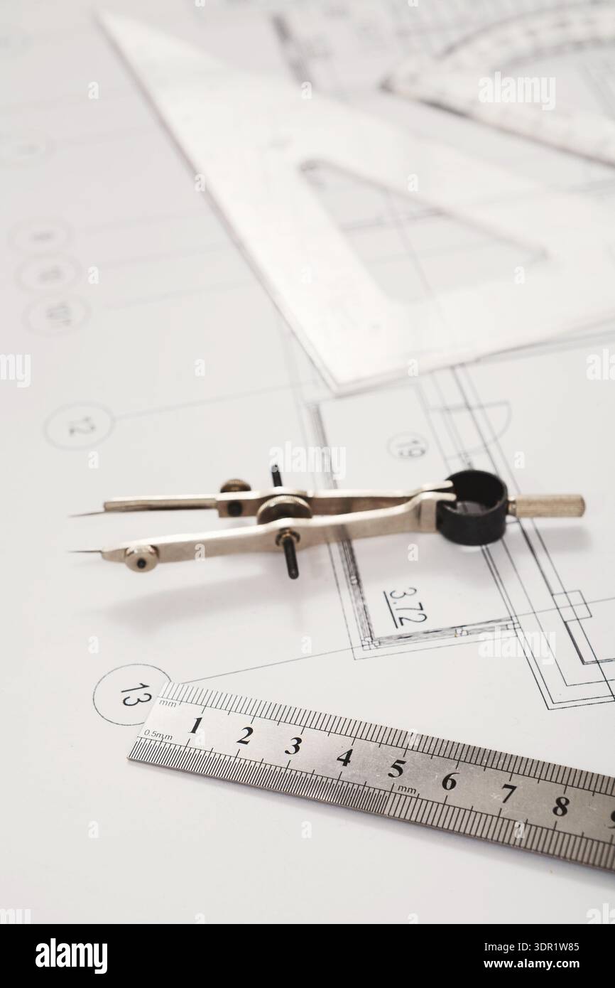Creating a Technical Drawing With Tools and Plans on a Workspace Table During the Daytime Stock Photo