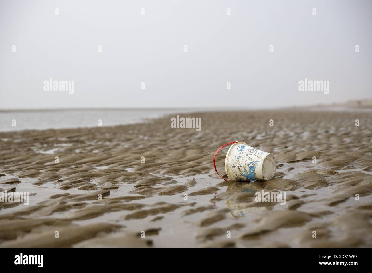 A discarded plastic cup is lying on a sandy beach, Blankenberge, Flanders, Belgium Stock Photo