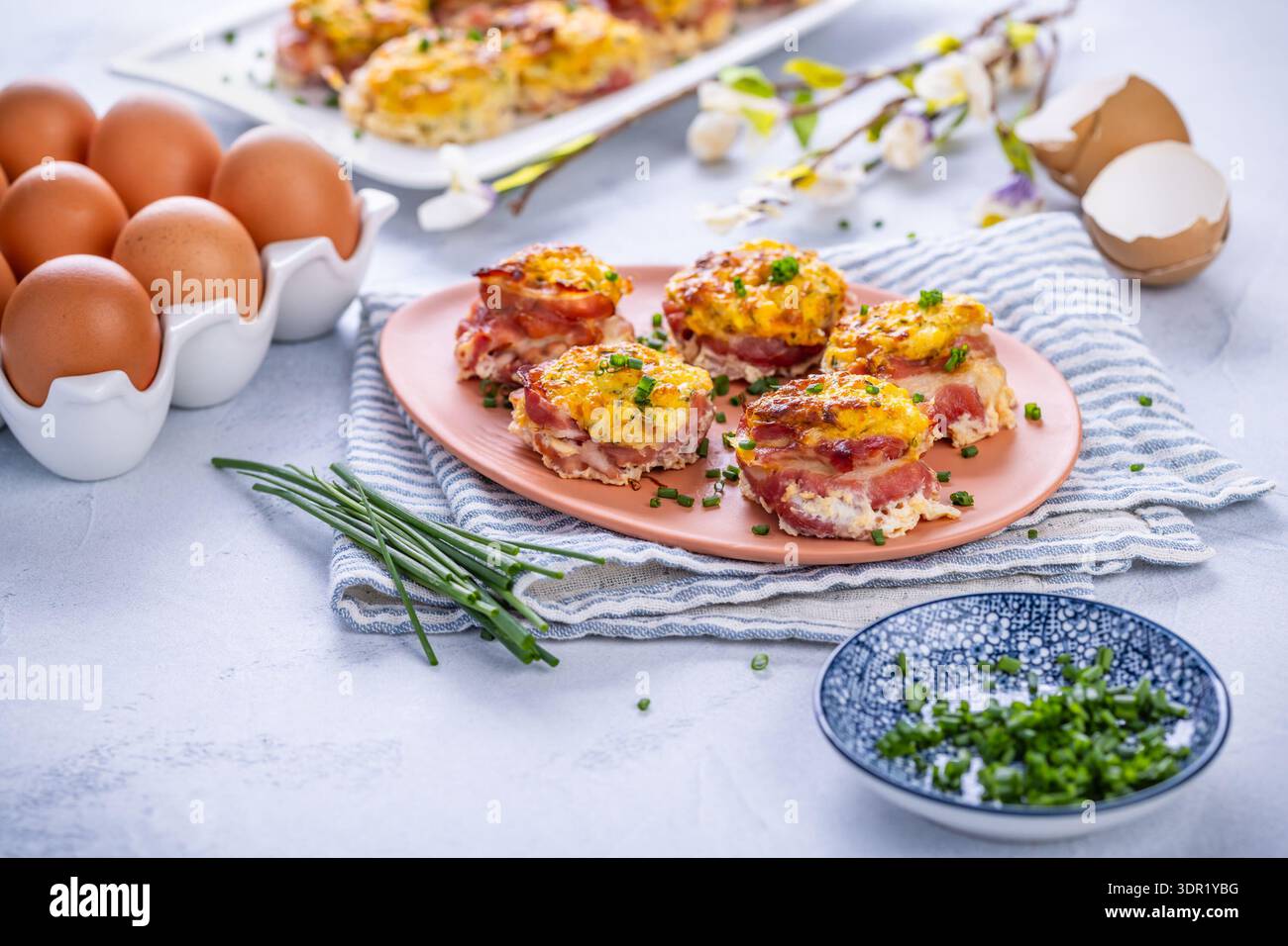 Bacon and eggs muffins for Easter brunch with chives Stock Photo