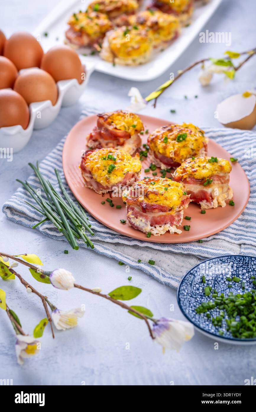 Bacon and eggs muffins for Easter brunch with chives Stock Photo