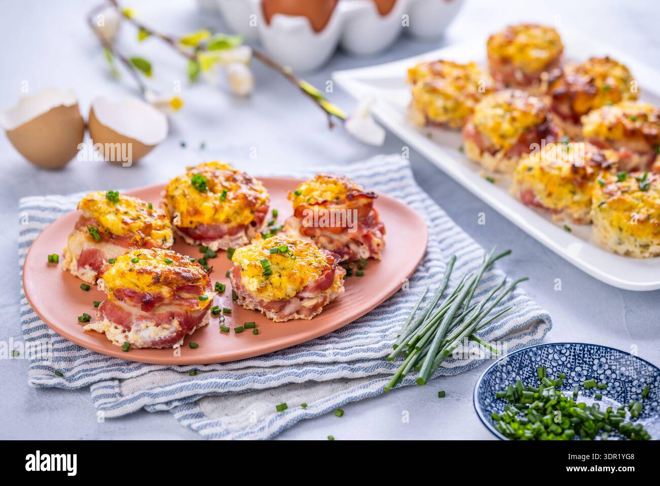 Bacon and eggs muffins for Easter brunch with chives Stock Photo
