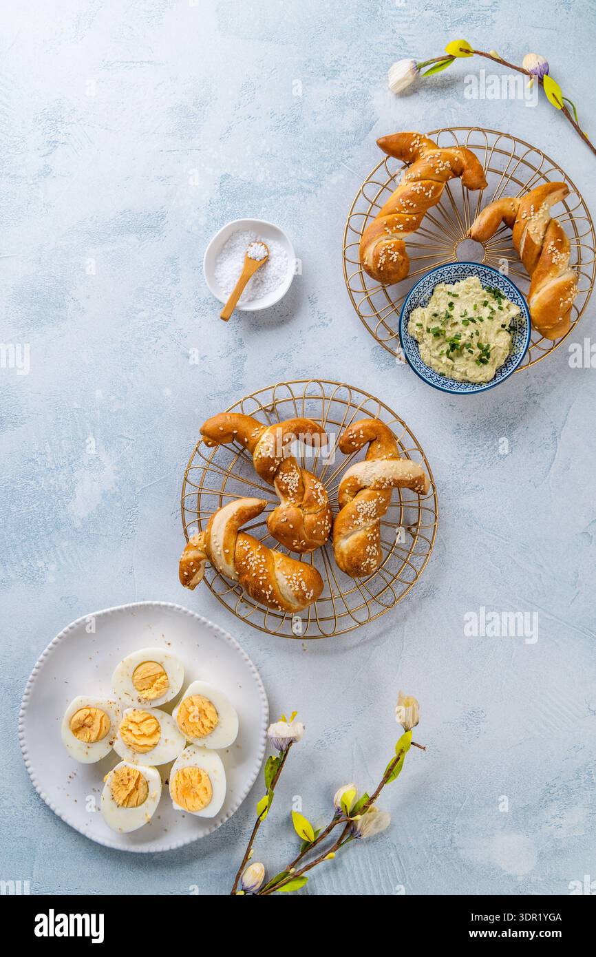 Easter brunch with bread bunny bun, egg spread and hard boiled eggs Stock Photo