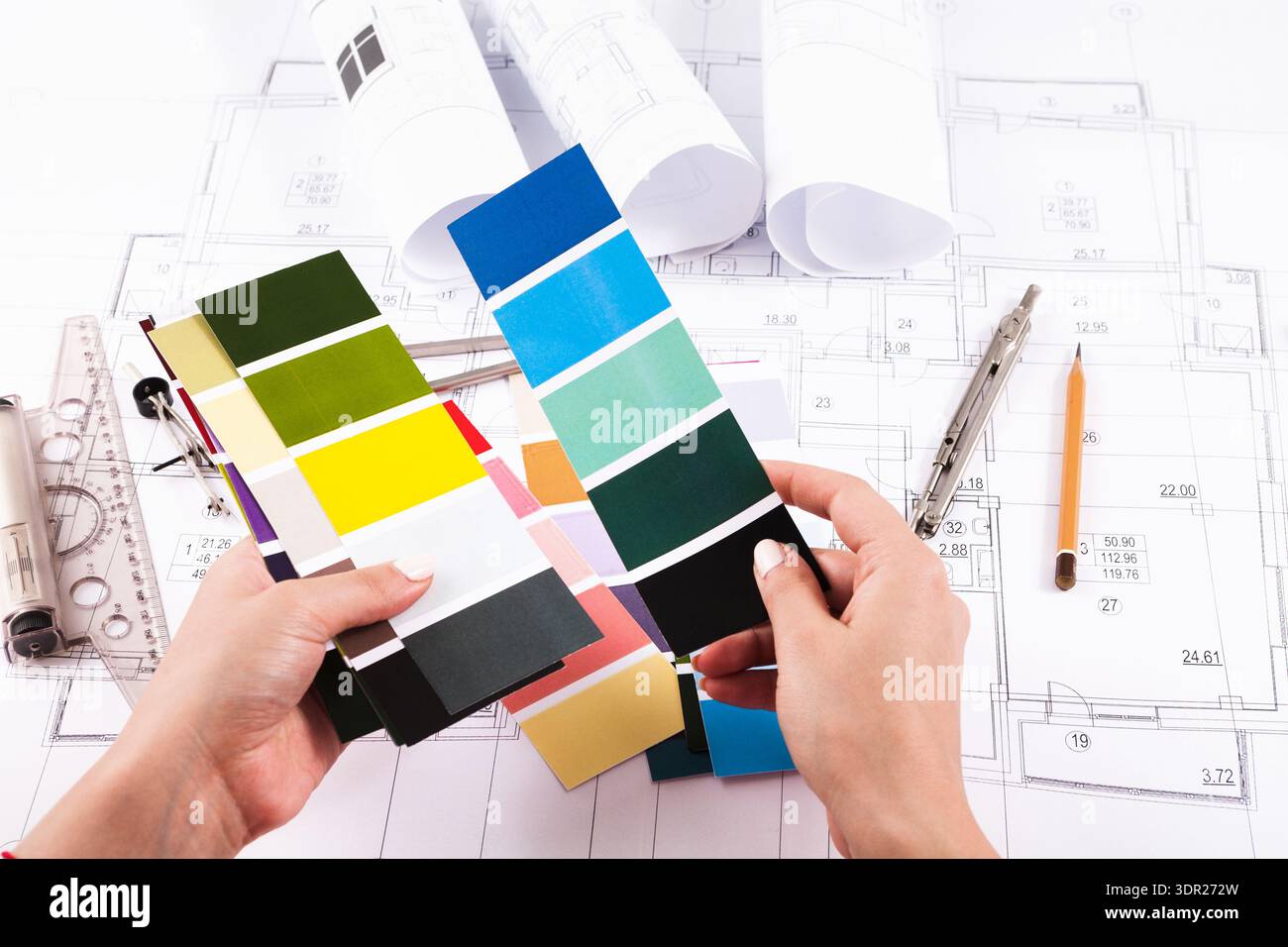 Color Selection in Design Process With Samples and Blueprints Displayed on a Table Stock Photo