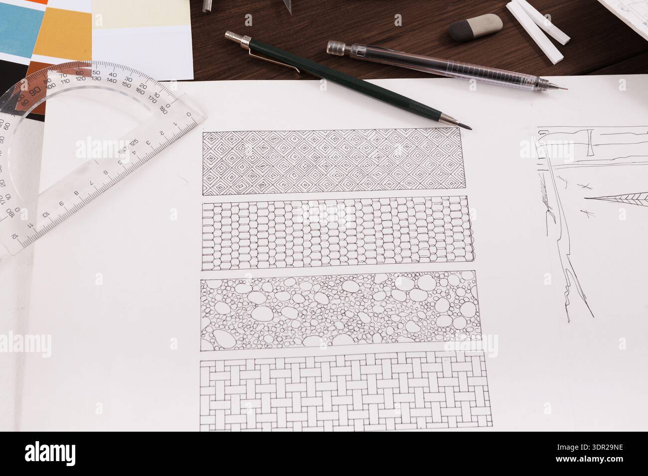 Collage of Pattern Designs Showing Detailed Sketches and Tools on a Workspace Table Stock Photo
