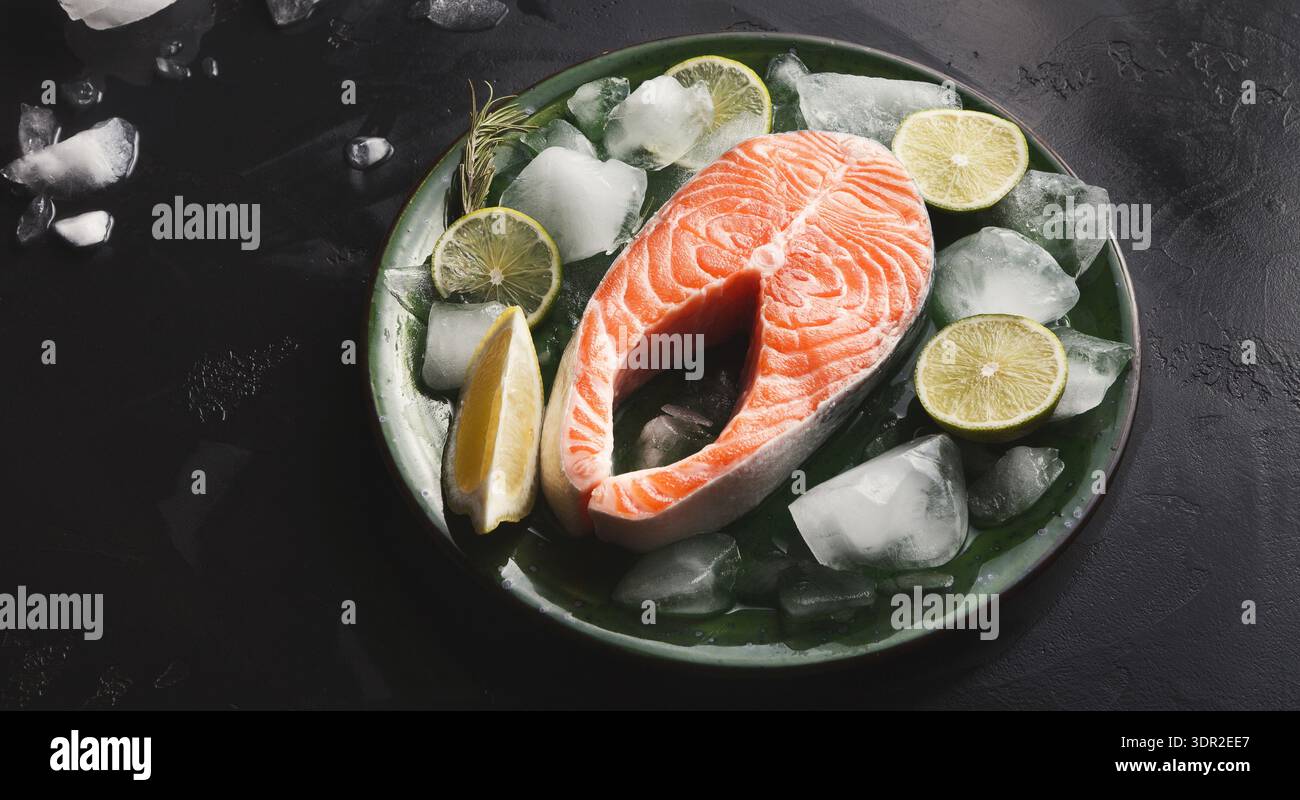 Collection of Salmon on Ice With Lime on a Dark Surface in a Kitchen Setting Stock Photo