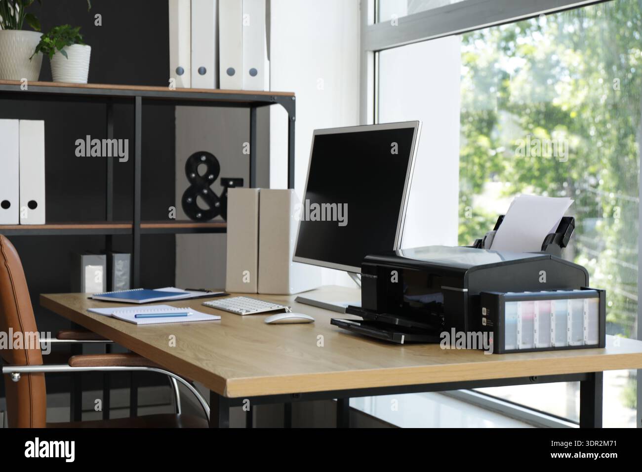Modern workplace with computer and printer near window in office Stock Photo