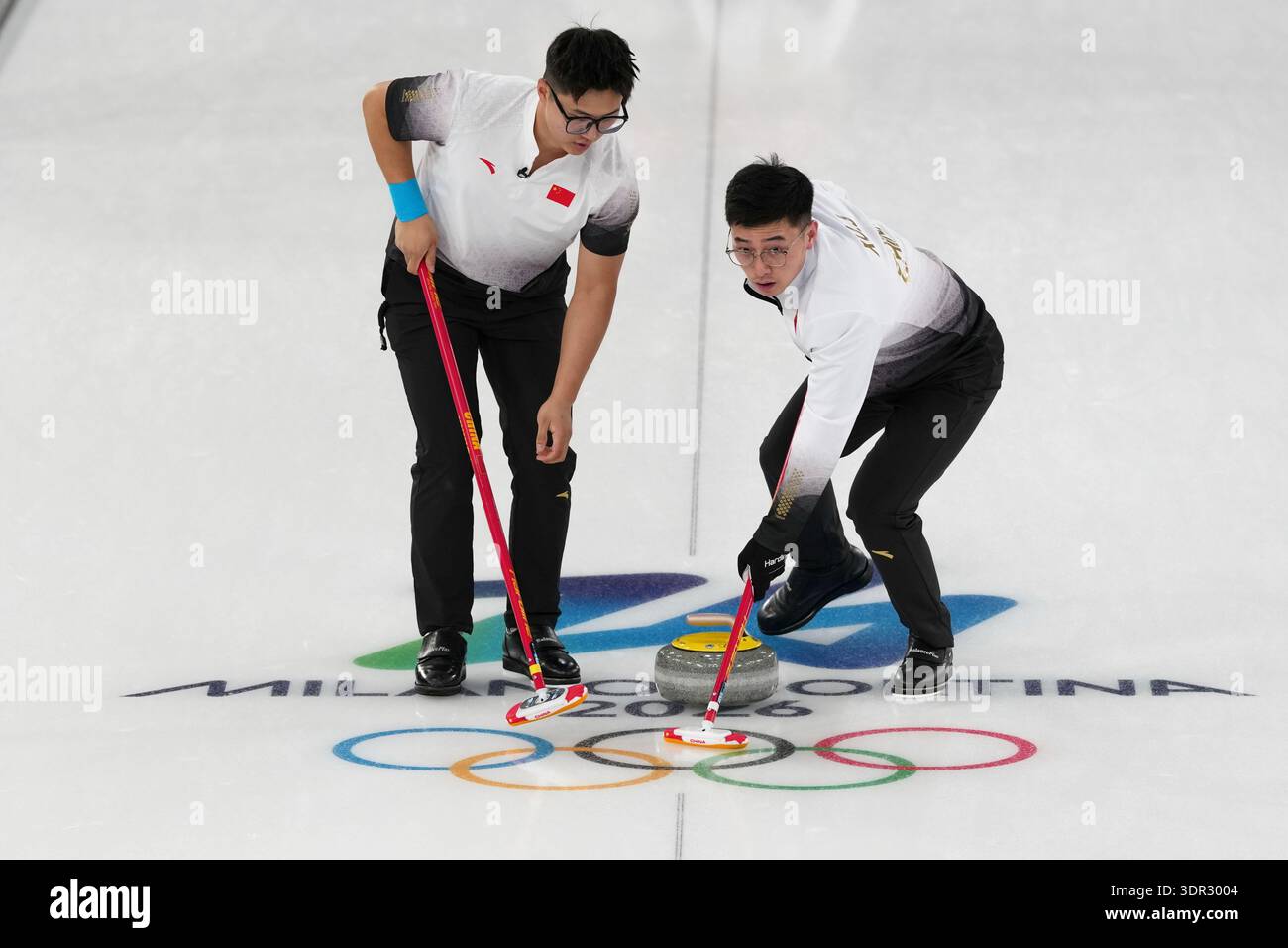 China's Li Zhichao and Xu Jingtao in action during the men's curling ...
