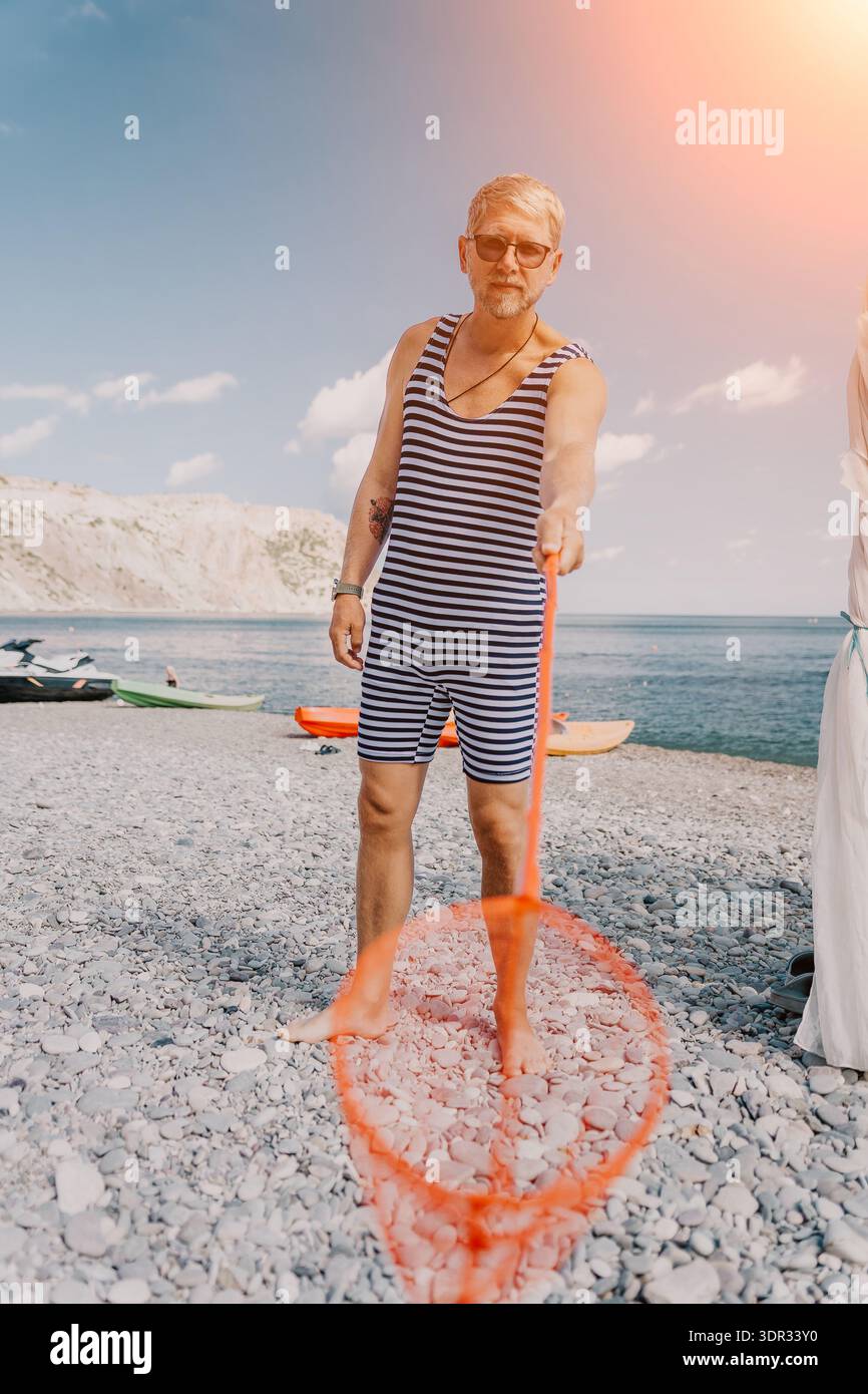 male beach dress Male Model Posing on the Beach Photograph – Poster Museum