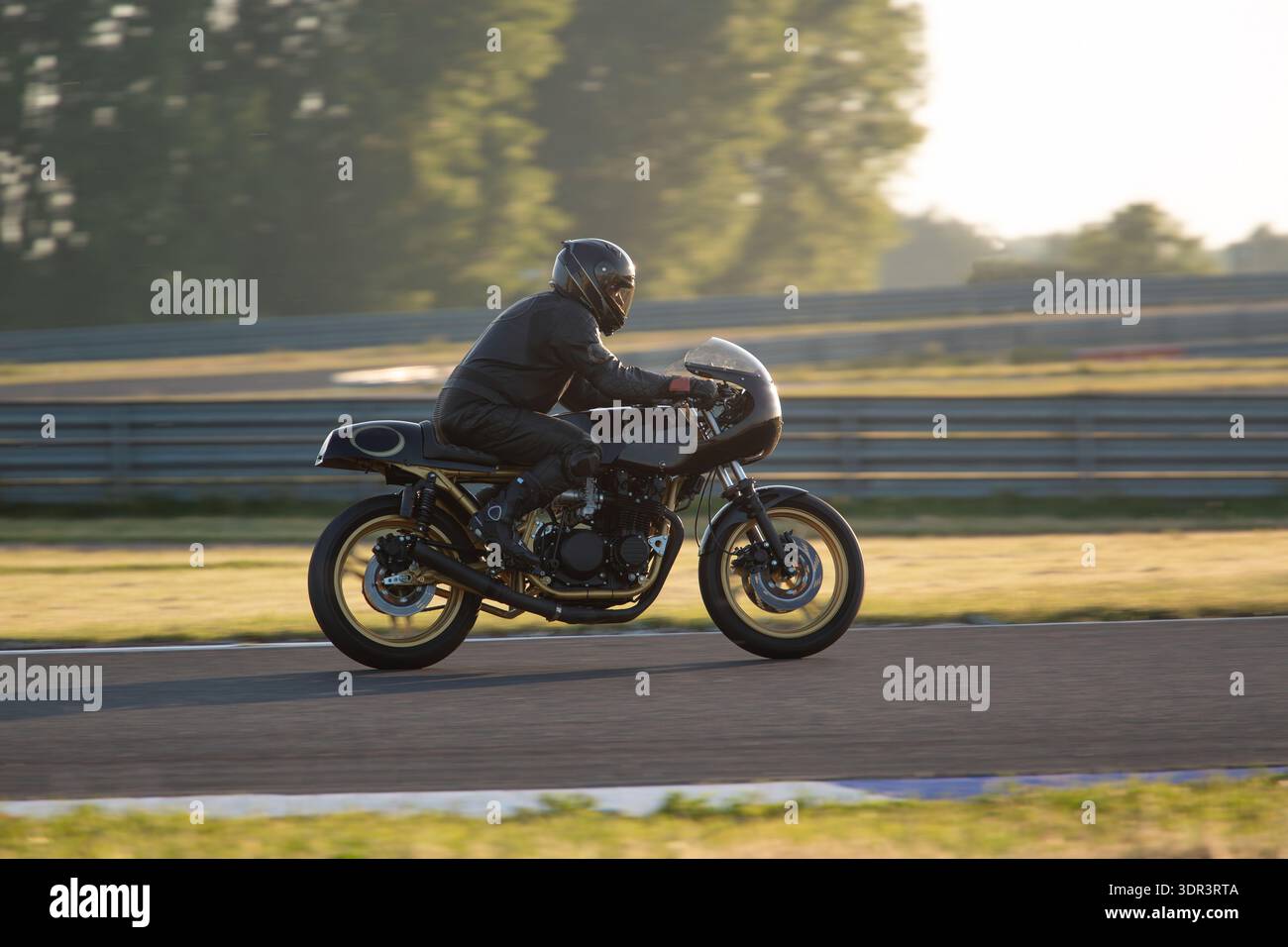 Profile Picture Racer Side profile of a motorcyclist in black leather gear riding a classic ...