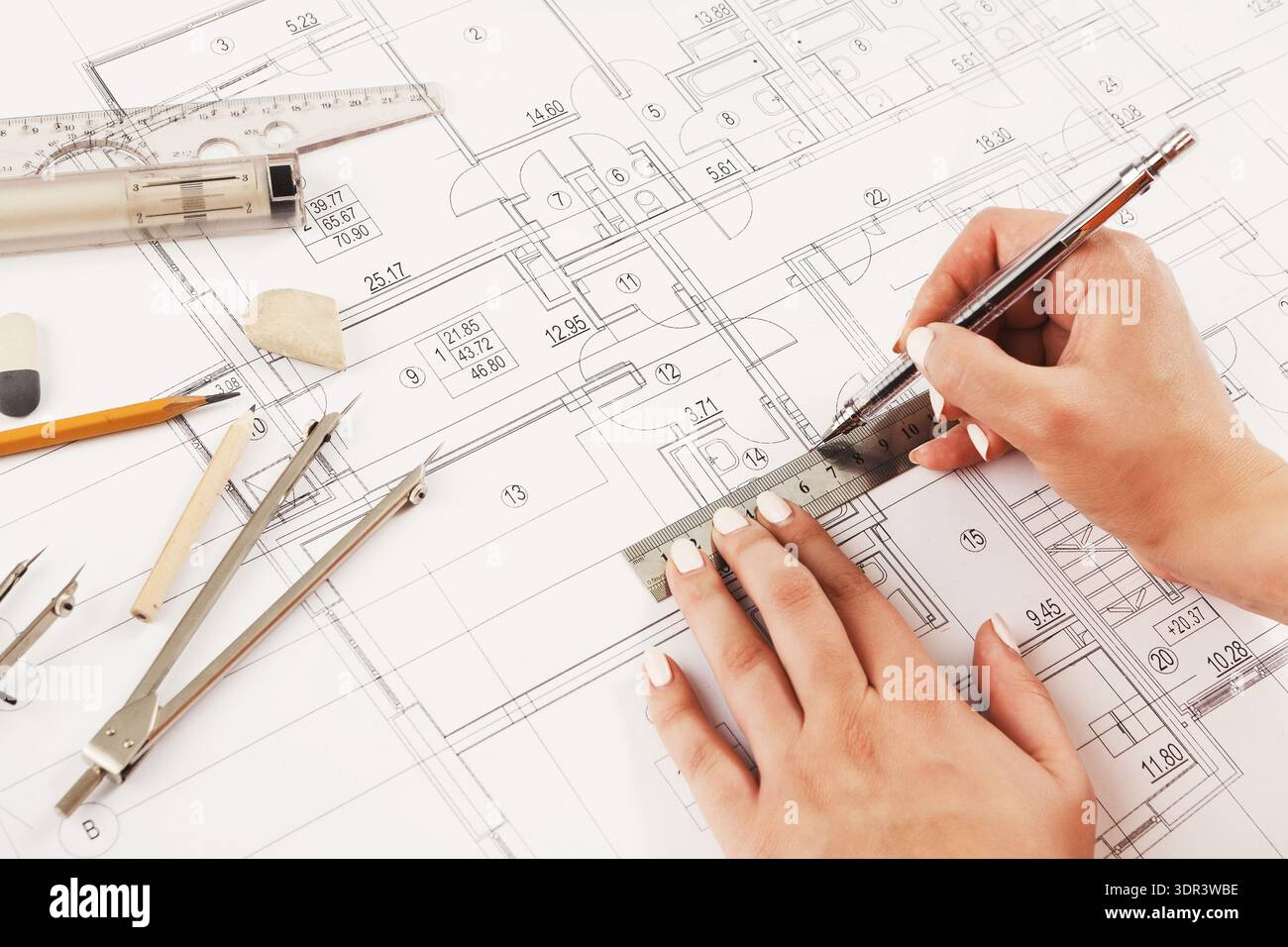 Drawing Plans on Paper With Tools for Creating a Building Design and Layout Stock Photo