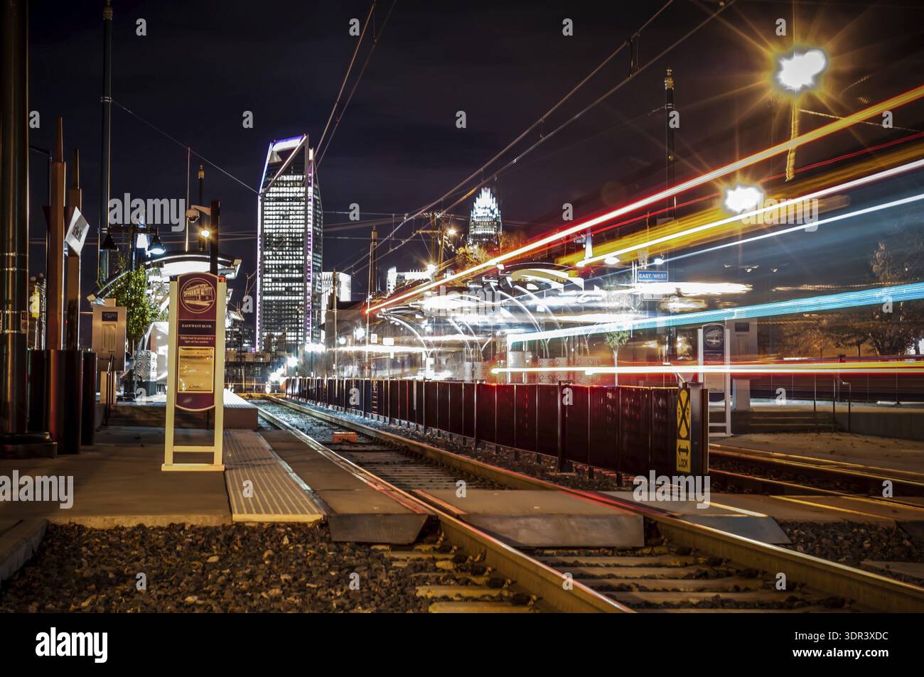 Charlotte City Skyline night scene with light rail system lynx train ...