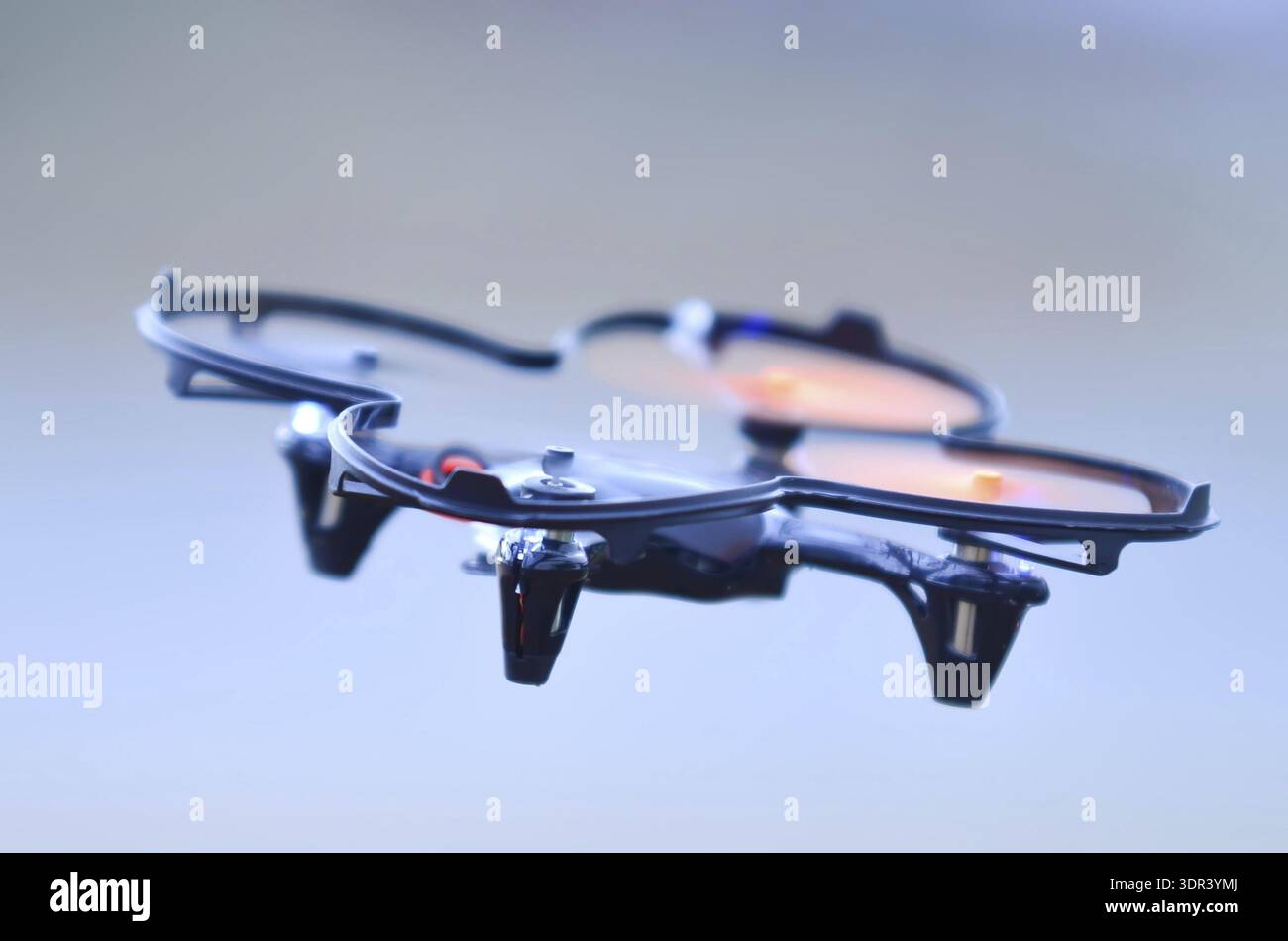 Remote controlled quadcopter drone in mid air Stock Photo