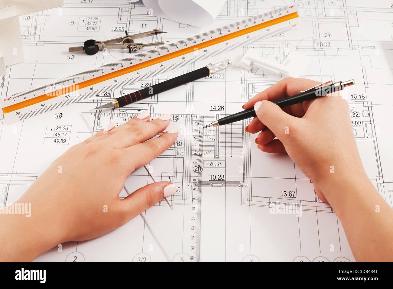 Create a Collage of Architectural Drawing Tools and Plans Displayed on a Workspace Stock Photo