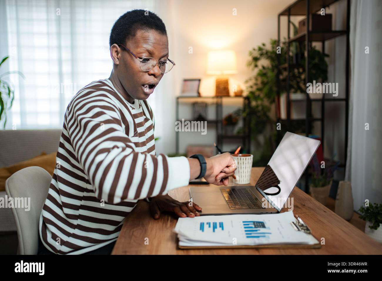 African American man feeling shock looking at smartwatch time Stock Photo