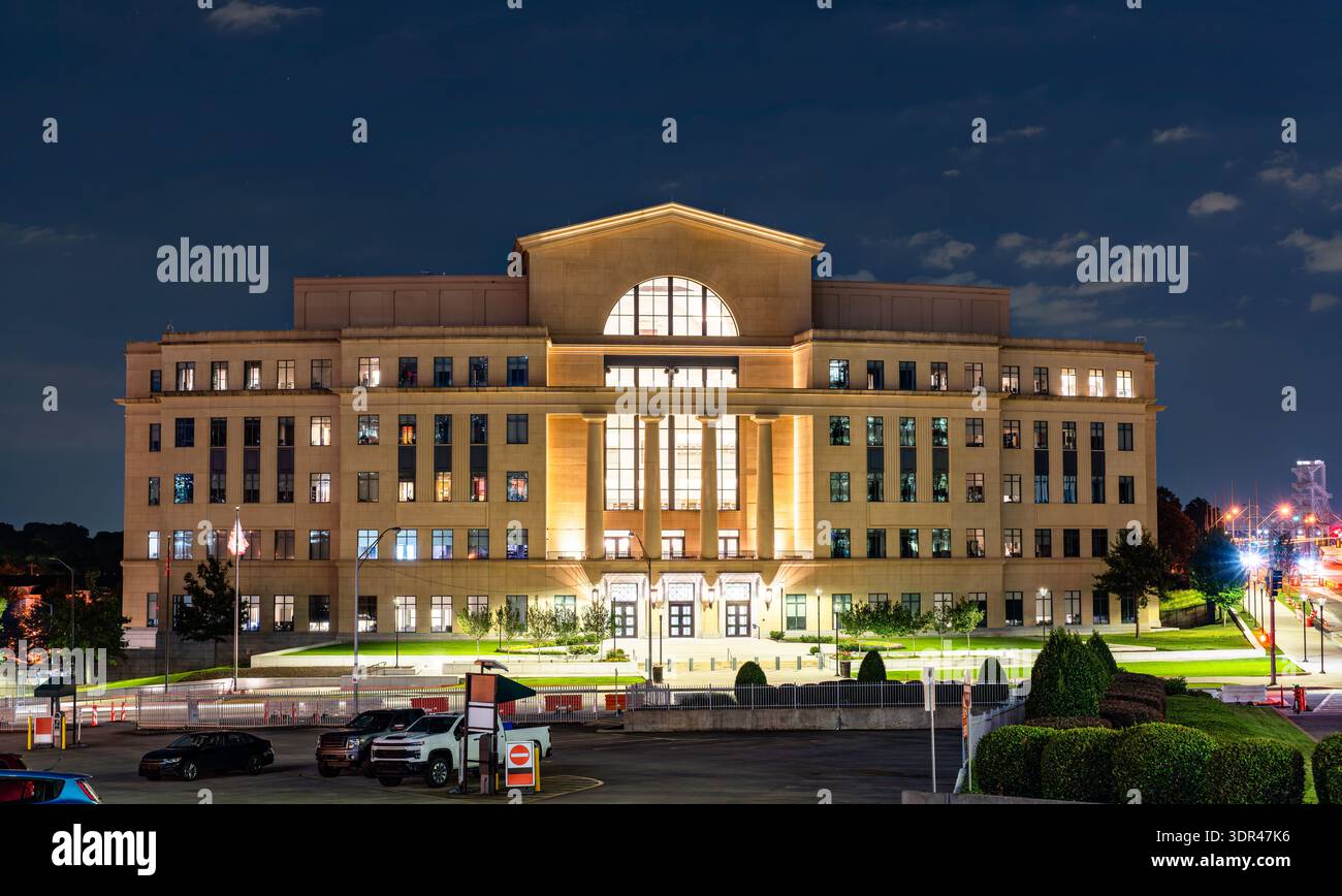Nathan Deal Judicial Center in Atlanta, Georgia. Modern government building features a stone facade with columns and large glass windows illuminated at night Stock Photo