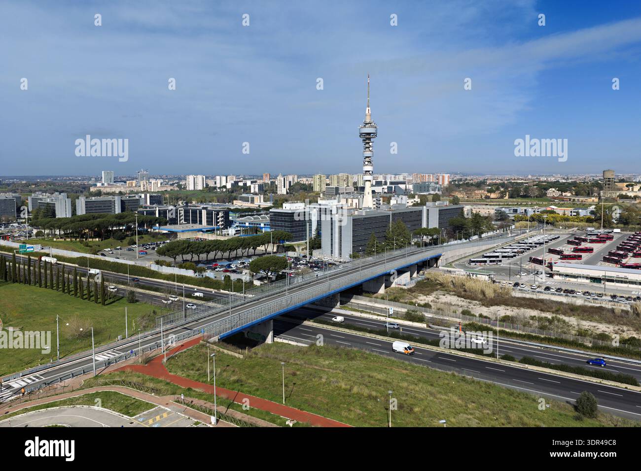 Aerial view of the prominent Telecom Italia Tower contrasting against the urban sprawl and highway below, Rome, Lazio, Italy. Stock Photo