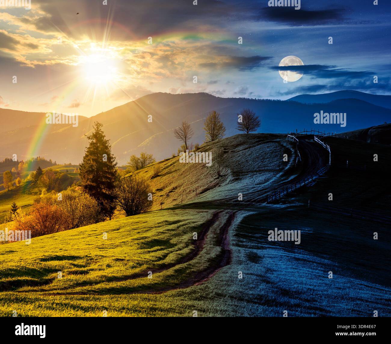 countryside scenery with grassy slopes. day and night time change concept. wooden fence along the dirt road through rolling hills. landscape of mounta Stock Photo
