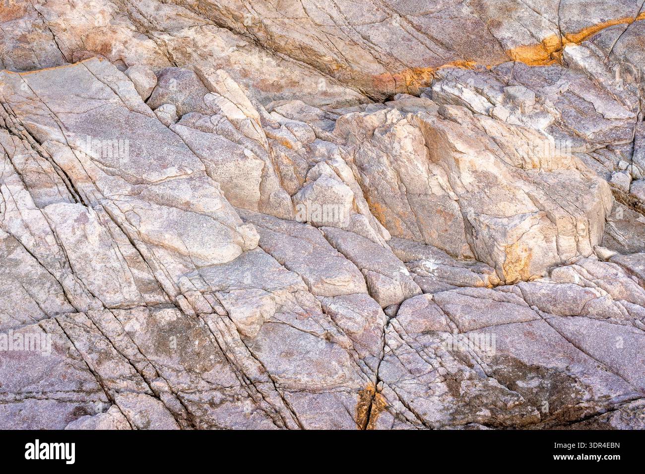 closeup of coast rock texture. rough stone background from the black sea in summer. detail of bulgaria rugged shore. backdrop for material design Stock Photo