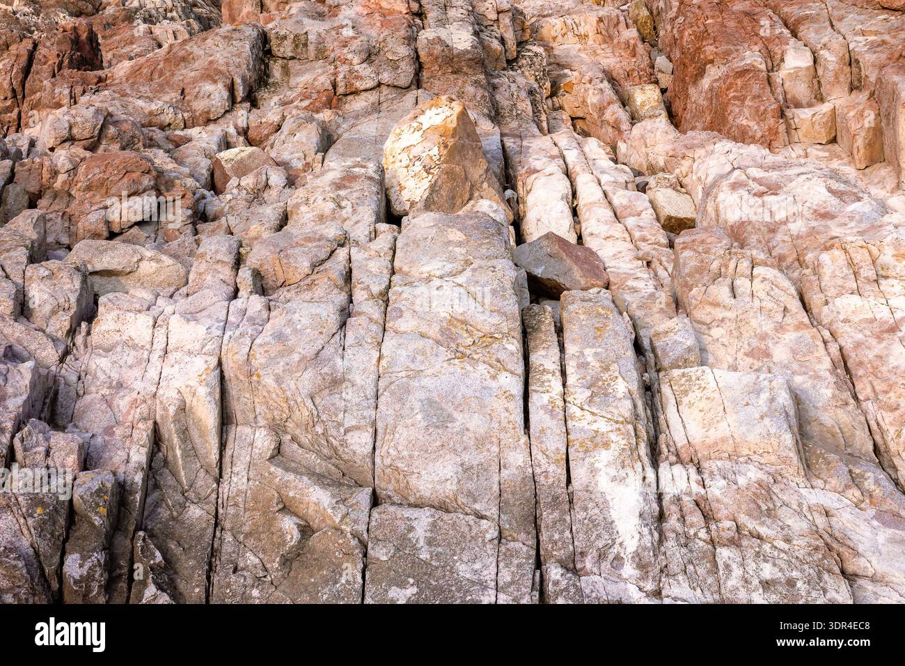 closeup of coast rock texture. rough stone background from the black sea in summer. detail of bulgaria rugged shore. backdrop for material design Stock Photo