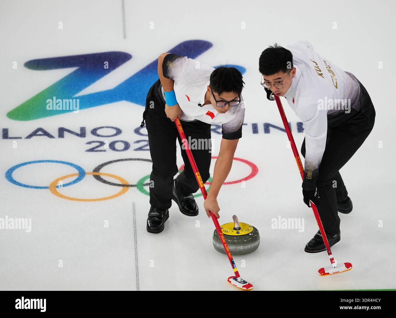 Cortina D'ampezzo, Italy. 17th Feb, 2026. Li Zhichao (L) and Xu Jingtao ...