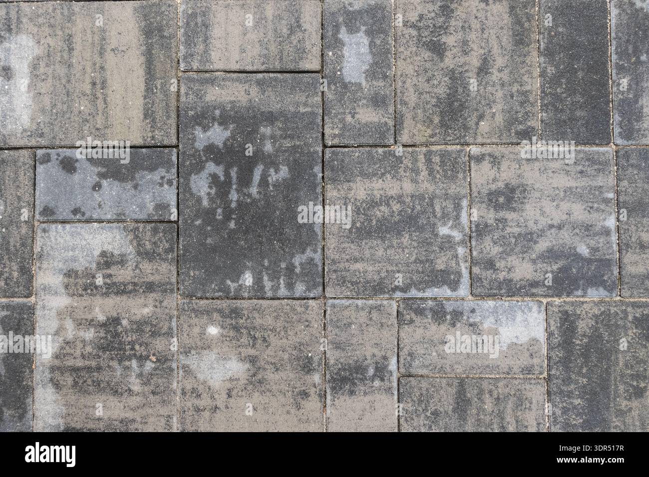 Grey stone pavement with rectangular concrete pavers forming textured urban surface pattern Stock Photo