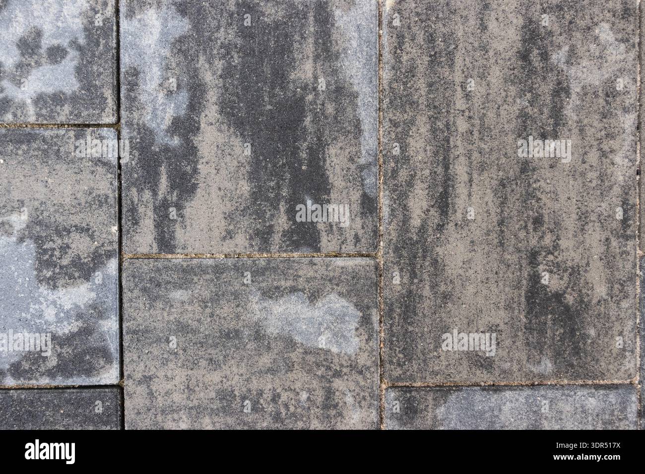 Grey stone pavement with rectangular concrete pavers forming textured urban surface pattern Stock Photo