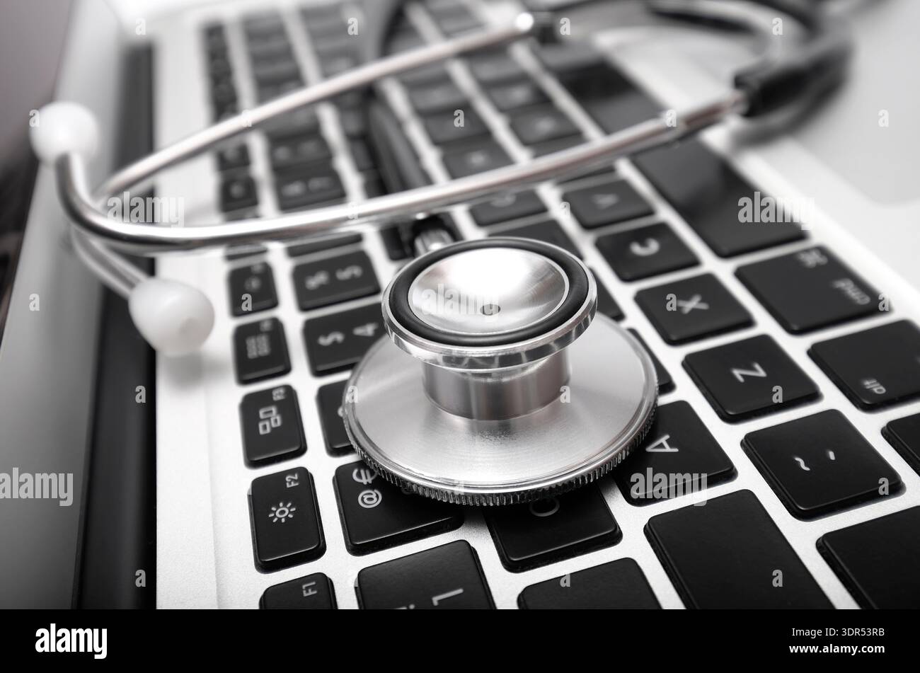 doctor's stethoscope on laptop computer keyboard Stock Photo