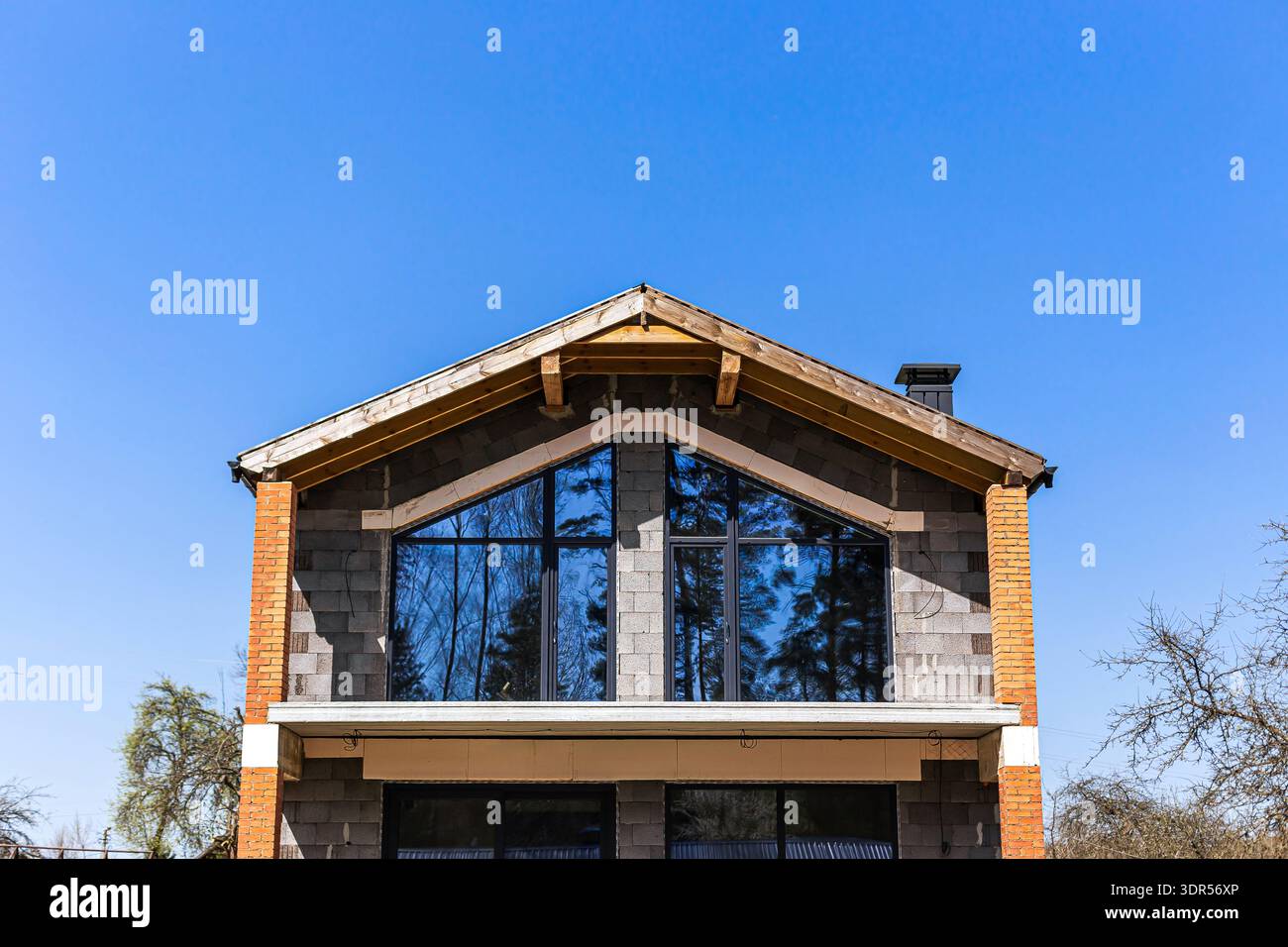 Modern house facade under construction with large panoramic windows and ...