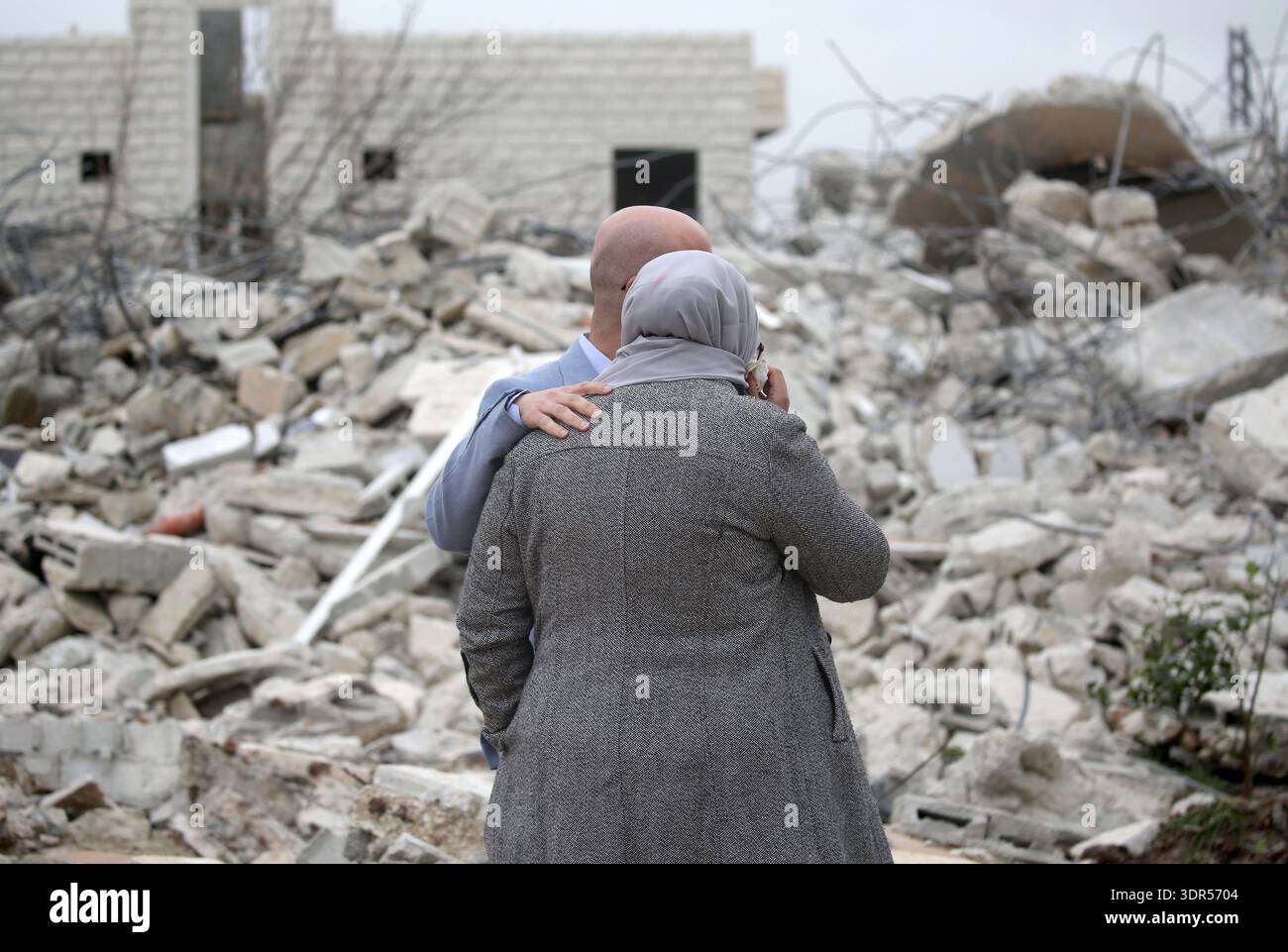 A Palestinian family weeps as their home is demolished in the al-Ta ...