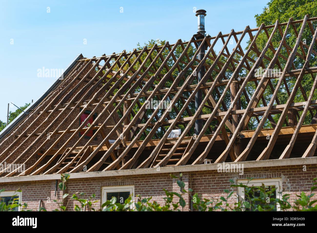 Timber roof skeleton of a countryside building exposed during ...