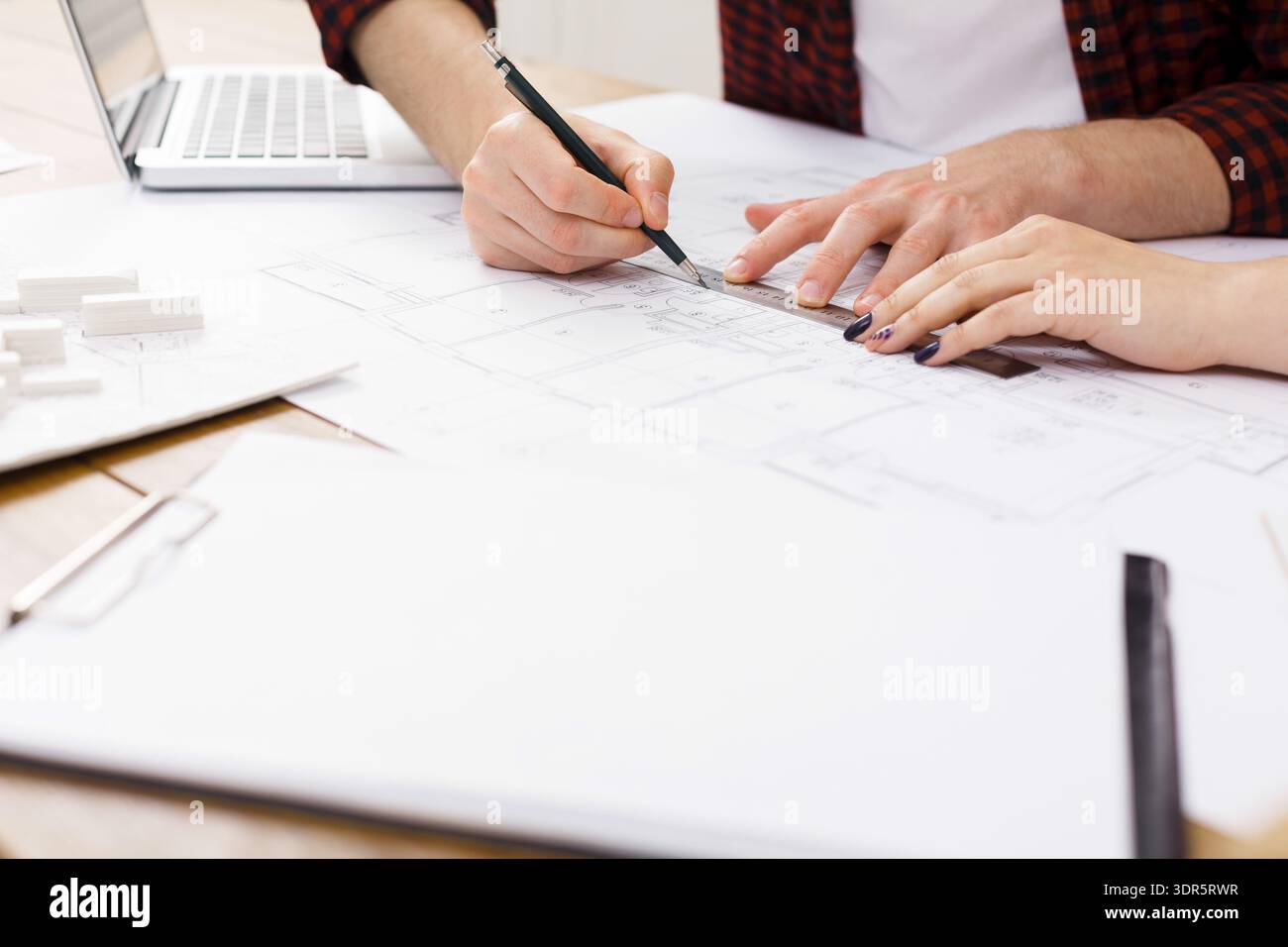 Planning a Construction Project at a Workspace With Design Documents and Tools on the Table Stock Photo