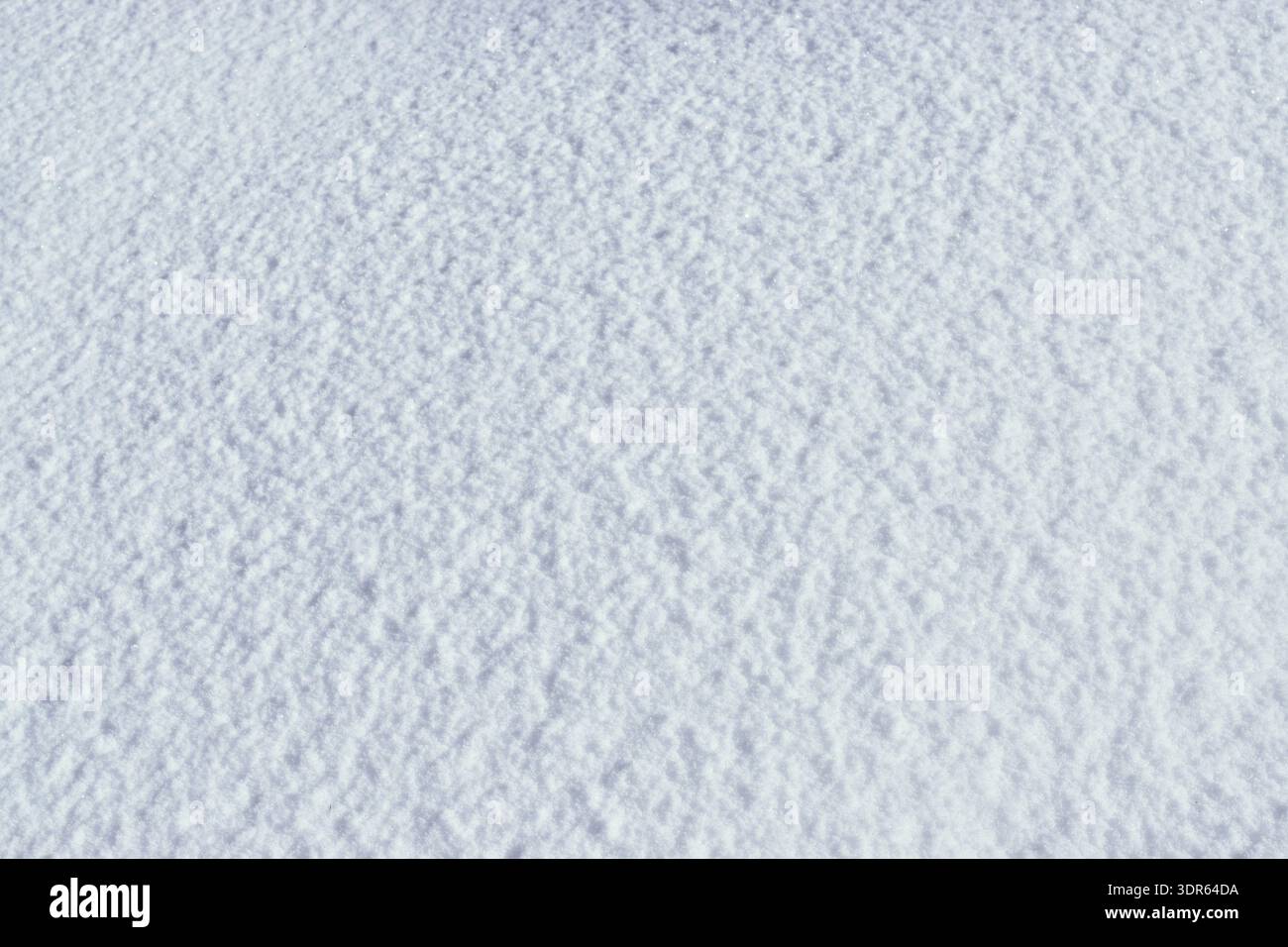 Minimalist winter texture featuring long blue shadows on pristine white snow. Stock Photo