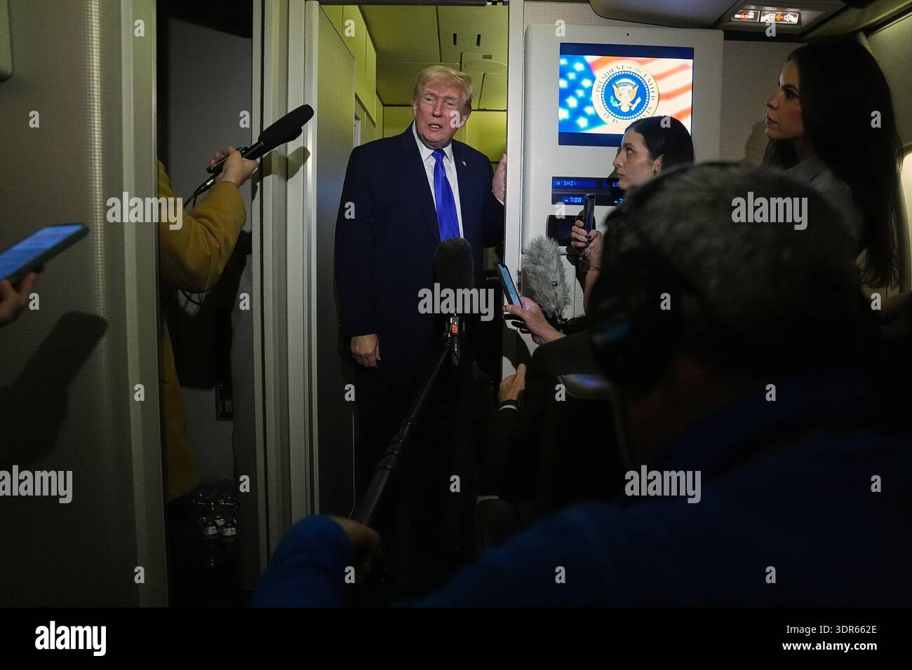 President Donald Trump speaks with reporters aboard Air Force One ...