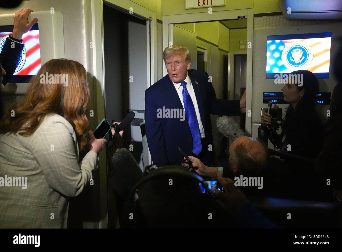 President Donald Trump speaks with reporters aboard Air Force One ...