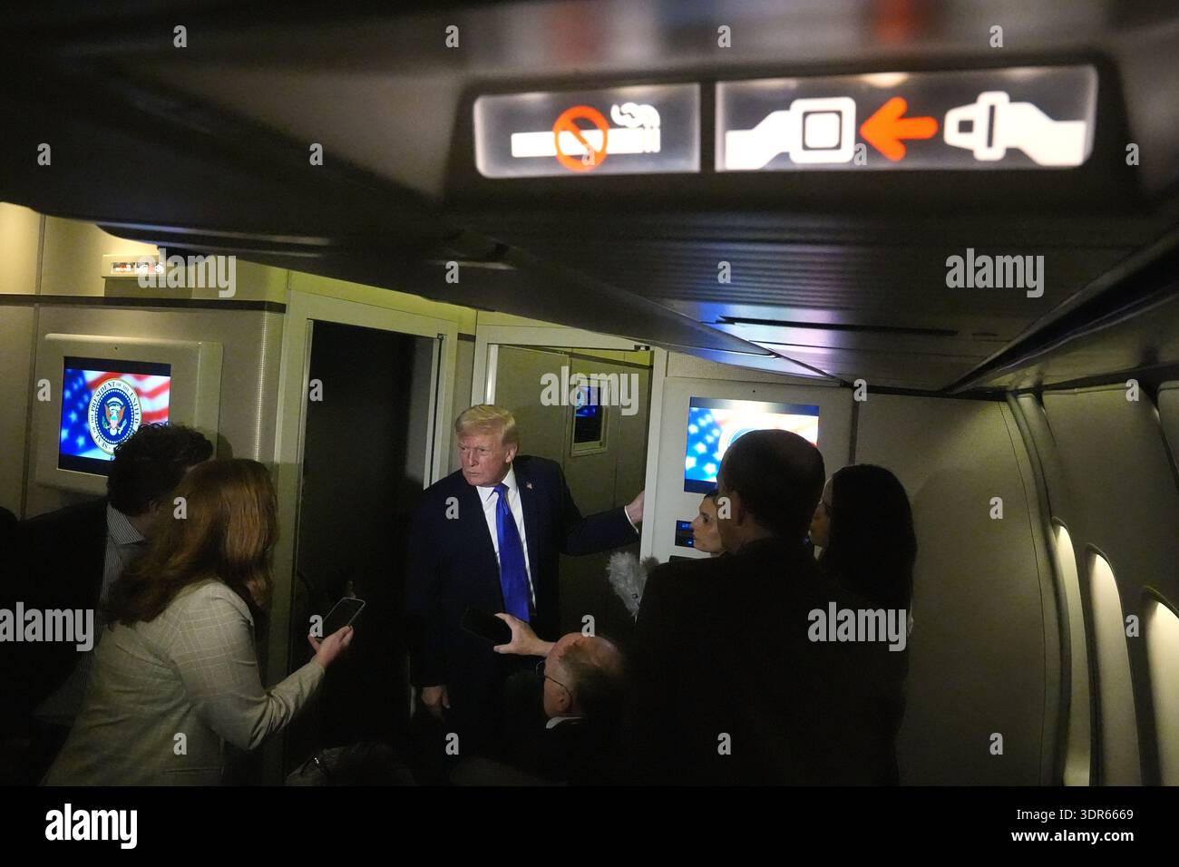 President Donald Trump speaks with reporters aboard Air Force One ...