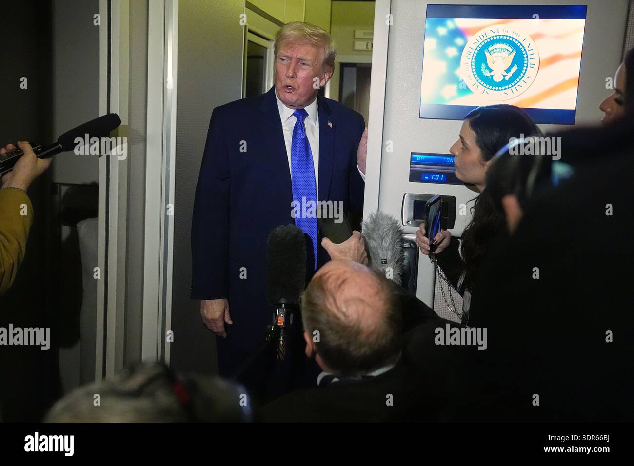 President Donald Trump speaks with reporters aboard Air Force One ...
