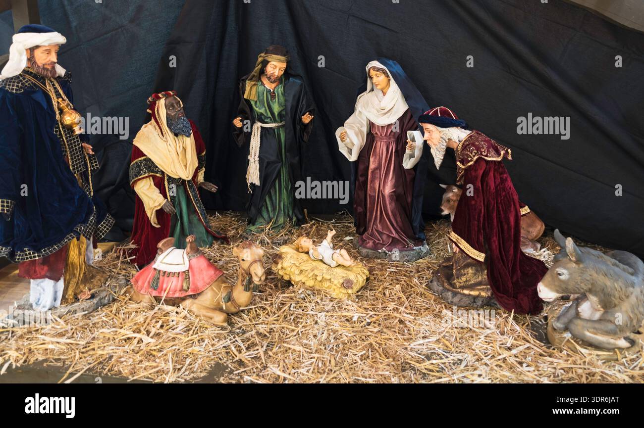 Nativity scene showing the baby Jesus and three wise men in a stable ...