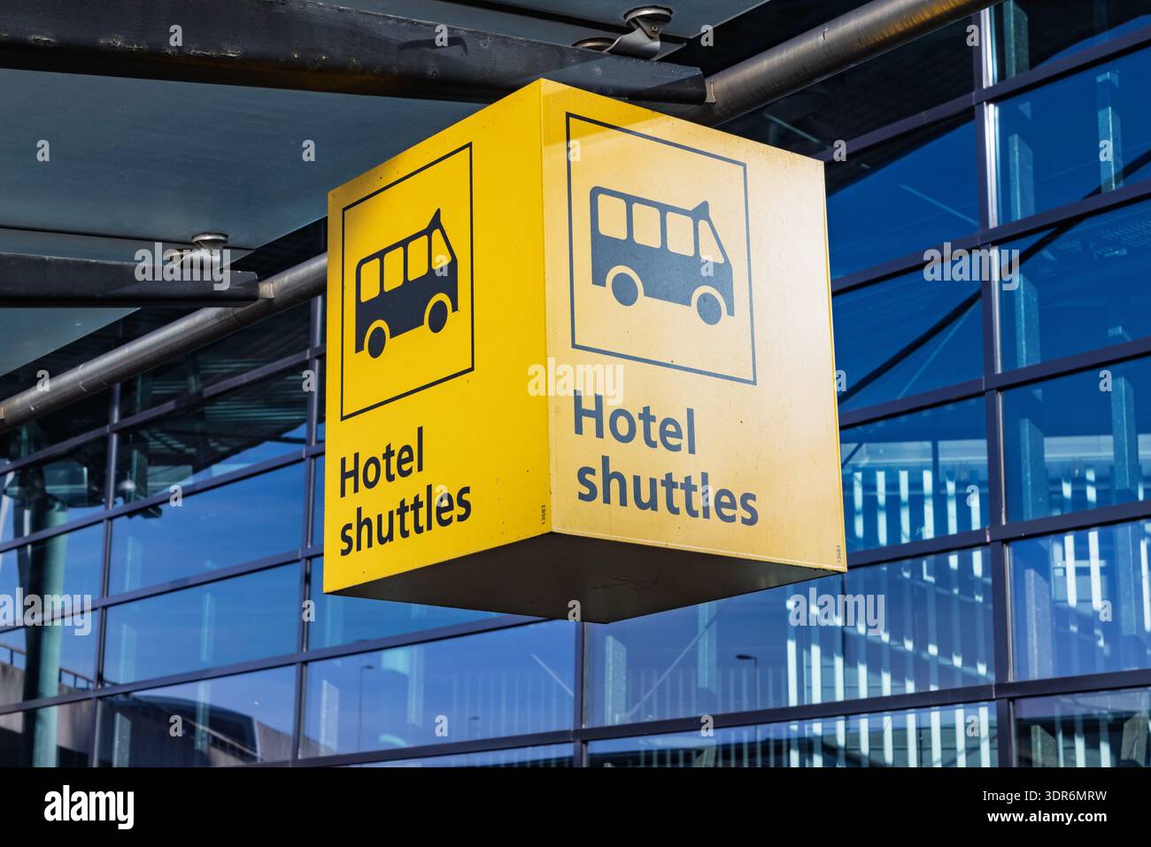 Yellow directional signage for hotel shuttle bus services at Amsterdam ...