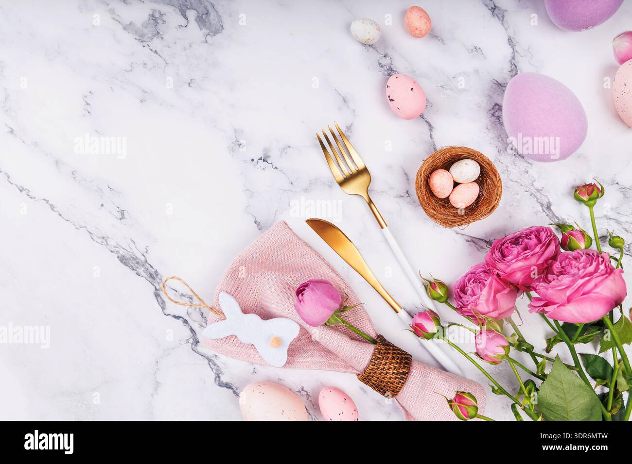Easter Celebration Setting with Roses and Eggs. Stock Photo