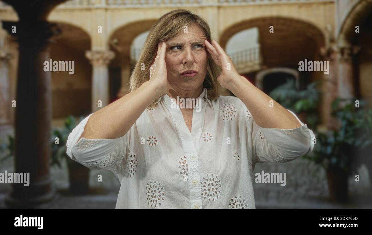 Woman clutching temples on sunlit hi-res stock photography and images ...