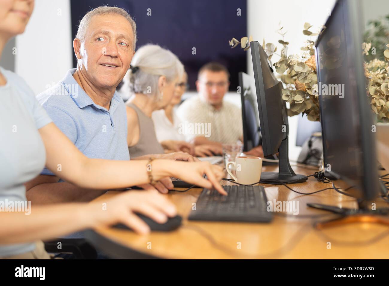 Group of older people studying on computer course Stock Photo