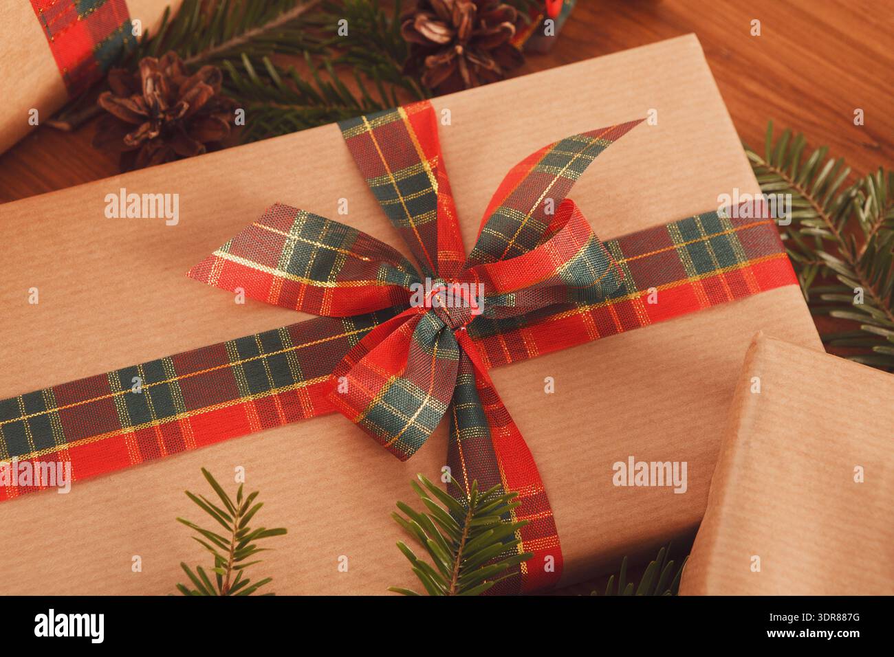 Different Gift Boxes With Ribbons and Decorations on a Wooden Table in a Festive Setting Stock Photo