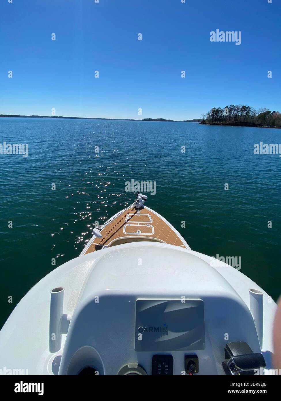 Looking over bow of fishing boat on tuna tower during a beautiful sunny day with deep blue sky and water. - Smartphone Captured Stock Image