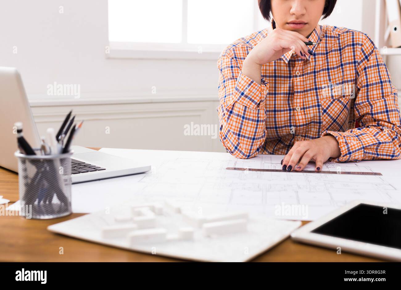 Student Works on Architectural Project With Plans and Models in Workspace During Daytime Stock Photo