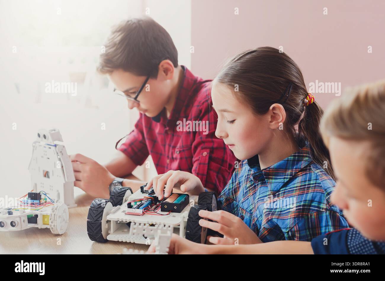 Students Build and Program Robots During a Workshop in a Classroom in the Afternoon Stock Photo
