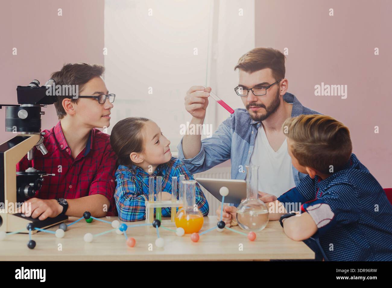 Students Learn Science Concepts Through Hands-On Experiments in a Classroom Setting Stock Photo