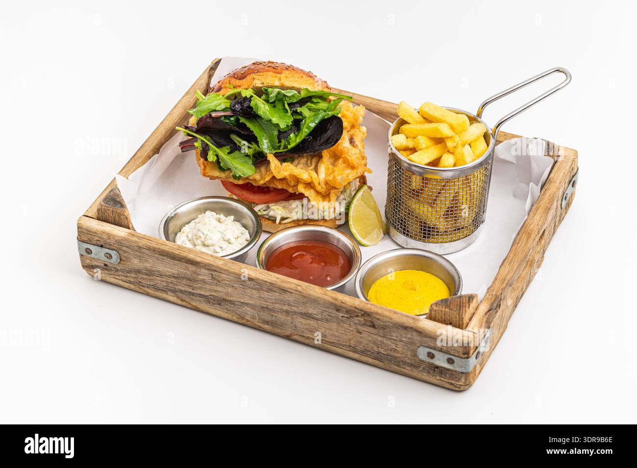 Crispy fried chicken burger served with fries and creamy dips Stock Photo