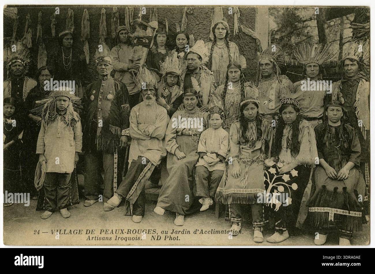 Peaux Rouges Et Indigenes This 1883 black-and-white photographic postcard depicts a group of ...